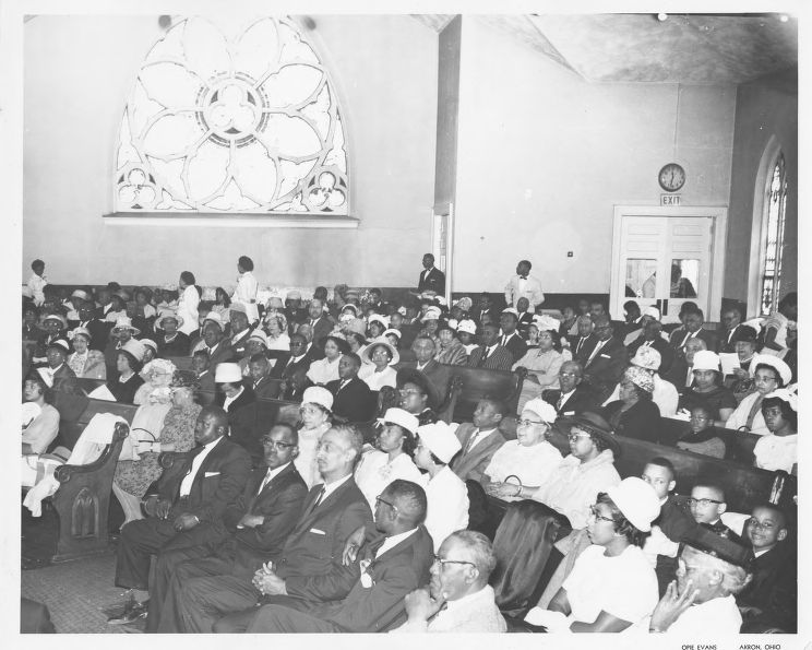 One black and white photographic print showing the congregation at the Second Baptist Church at 188 E. Center Street in Akron, Ohio. The congregation at Second Baptist Church located on East Center Street in Akron gathers to listen to a sermon.